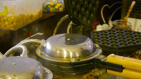 Making Hong Kong style egg waffle. Waffle irons in the process of work Stock Footage 84252694