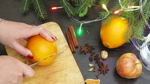 Making hot alcohol, cook mulled wine orange, apples and spices. drink in winter Stock Footage 220549452