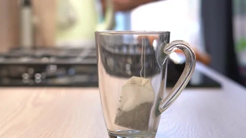 Making hot tea on the kitchen table. Stock Footage 284060342