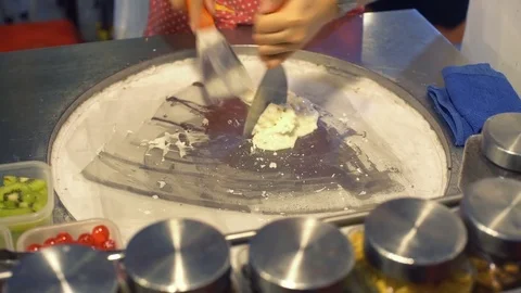 Making ice cream rolls on cold plate 4k UHD (3840x2160) Stock Footage 79925508