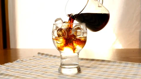Making iced dutch cold brew coffee with ice, water and cold brewed coffee Stock Footage 111302940