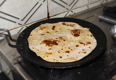 Making Indian Roti ,chapati ,fluke in the image. Stock Photos