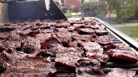 Making jerky in custom modified gas grill for smoking and drying meats Video stock 163368106