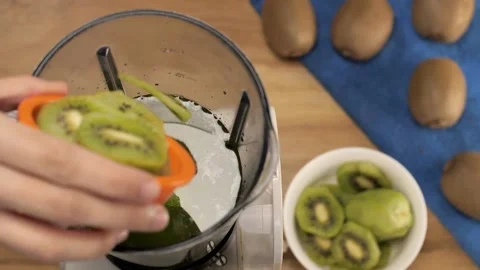Making a kiwi fruit smoothie in a blender - refreshing drink for healthy living Stock Footage 154154501
