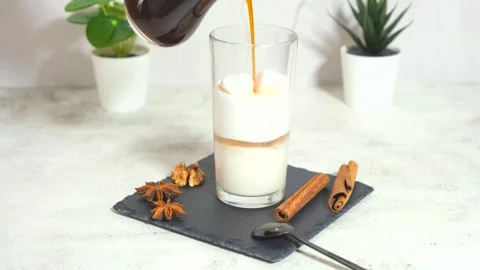 Making a latte, pouring coffee into a milk foam in a clear glass 스톡 동영상 170116035