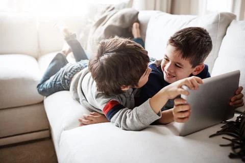 Making learning an interactive experience. two adorable brothers using a digital Stock Photos