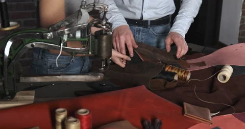 Making Leather Designer Products. Masters Choose Genuine Leather to Stitch Bag Stock Footage 132980207