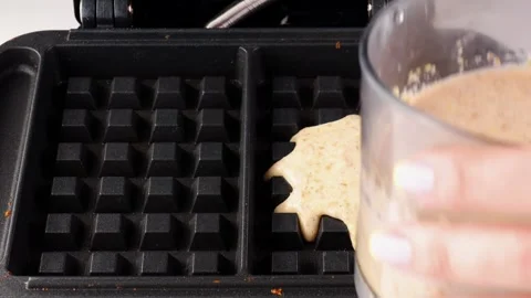 Making a lentil waffle. Remove the finished waffle from the hot waffle iron Stock Footage 274795392