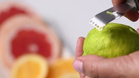Making lime zest with a mini grater. Stock Footage 131998513