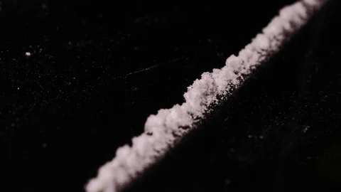Making  lines out of white powder for insuflation with a credit card . Video stock 82877267