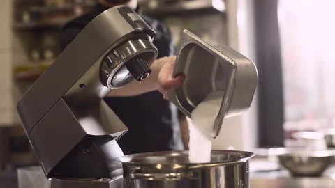 Making macarons. A silver kitchen table mixer kneads the dough for macarons. Stock-Footage 233294990