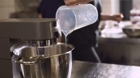 Making macarons. A silver kitchen table mixer kneads the dough for macarons. Stock Footage 233295121