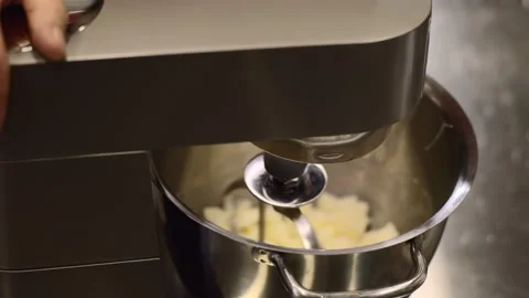 Making macarons. A silver kitchen table mixer kneads the dough for macarons. Stock Footage 233295247