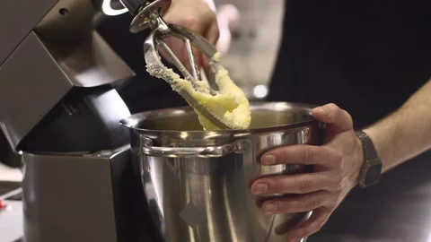 Making macarons. A silver kitchen table mixer kneads the dough for macarons. Stock Footage 233295307