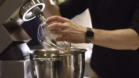 Making macarons. A silver kitchen table mixer kneads the dough for macarons. Stock Footage 233295423