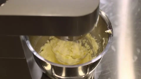 Making macarons. A silver kitchen table mixer kneads the dough for macarons. Stock Footage 233295627