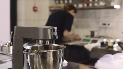 Making macarons. A silver kitchen table mixer kneads the dough for macarons. Stock Footage 233296098