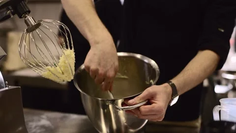 Making macarons. A silver kitchen table mixer kneads the dough for macarons. Stock Footage 233296212