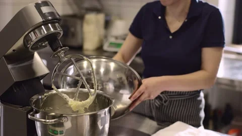 Making macarons. A silver kitchen table mixer kneads the dough for macarons. Stock Footage 233296859