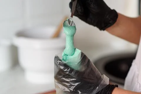Making macaroons.The dough for macaroons is placed in a pastry bag. Stock Photos