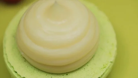 Making macaroons, filling green macaroons with cream, macro Stock Footage 101742483