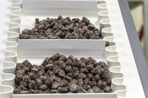 Making machine of chocolate sweets. Chocolate factory. Sweets production process Stock Photos
