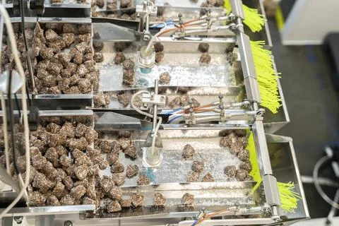 Making machine of chocolate sweets. Chocolate factory. Sweets production process Stock Photos