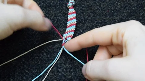 Making a macrame bracelet Stock Footage 72977993