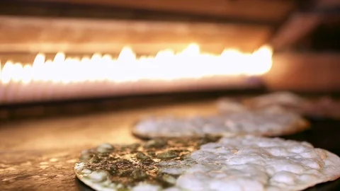 Making Manakeesh inside a gas heated oven, slow motion Stock Footage 119556460