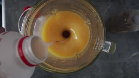 Making mango smoothie or mango juice with milk. Healthy food concept. Stock Footage 220735529