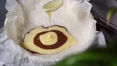 Making marble or zebra cake. Pouring chocolate and white dough Video stock 181997702