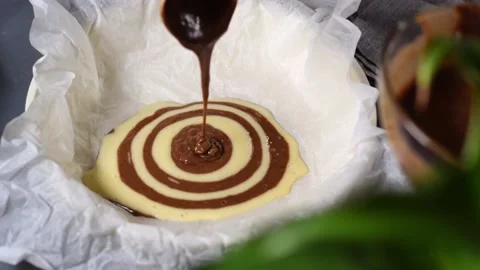 Making marble or zebra cake. Pouring chocolate dough Video stock 181997741