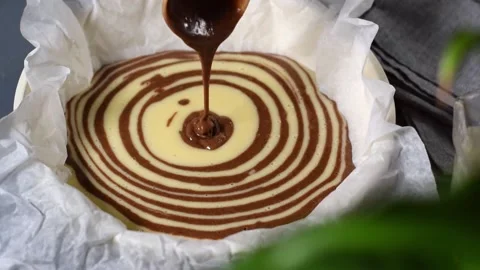 Making marble or zebra cake. Pouring chocolate and white dough Video stock 181997778