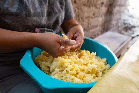 Making mashed potatoes with dirty hands in a plastic bowl Stock Photos