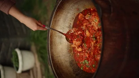 Making Meal Outdoor On Open Fire In Cauldron Video stock 238978520