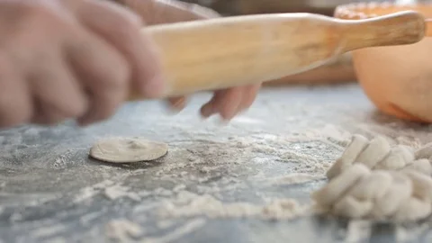 Making meat dumpling with wooden rolling pin. Stock Footage 74525800