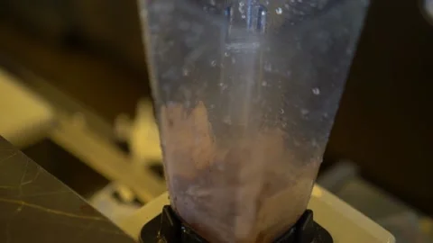 Making a milk drink in a mixer Stock Footage 167587797