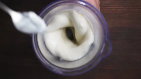 Making a milkshake. In a blender lower ice cream and mix. Slow motion. High Stock Footage 138998917