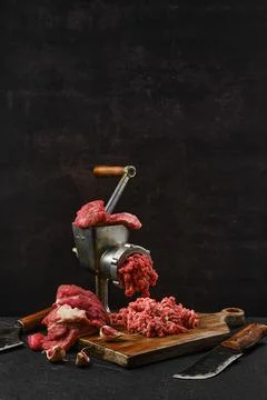 Making minced beef meat with oldfashioned meat grinder Stock Photos