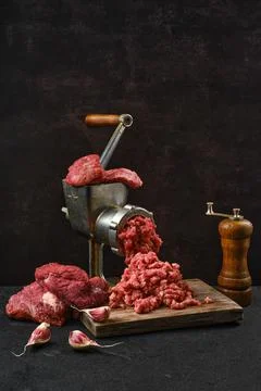 Making minced beef meat with oldfashioned meat grinder Stock-Fotos