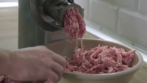 Making minced meat in electric grinder from fresh pork at home in the kitchen Stock Footage 165055939