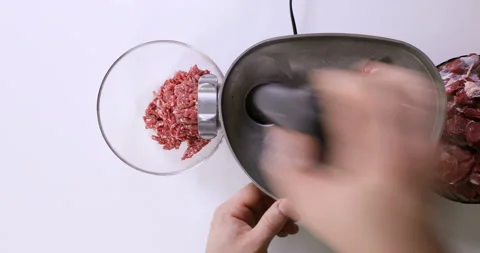 Making minced meat in an electric meat grinder from fresh beef at home,  Stock Footage 96679565