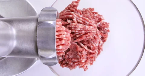 Making minced meat in an electric meat grinder from fresh beef at home Stock Footage 96679679