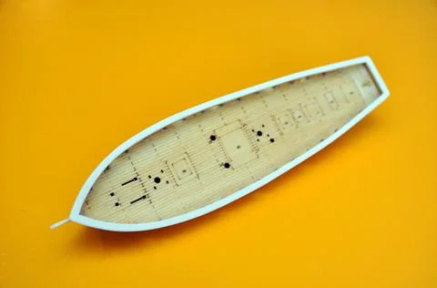 Making a model of a sailing ship, the hull of the ship on a yellow background Stock Photos
