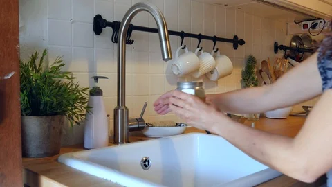Making moka coffee at kitchen. Home breakfast routine. a woman filled Italian Stock Footage 128239378