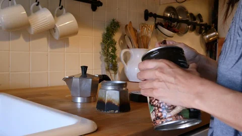 Making moka coffee at kitchen. Home breakfast routine. a woman filled Italian Stock Footage 128239387