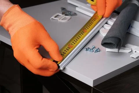 Making  mosquito net for  window Fotos de archivo