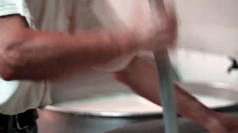 MAKING MOZZARELLA CHEESE MAN WORKING THE MILK Stock Footage 26742214