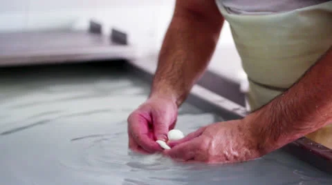MAKING MOZZARELLA CHEESE MODELLING A PACIFER MOZZARELLA CHEESE Stock Footage 26761900