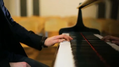 Making music. Profile of a handsome man playing piano Stock Footage 77524515